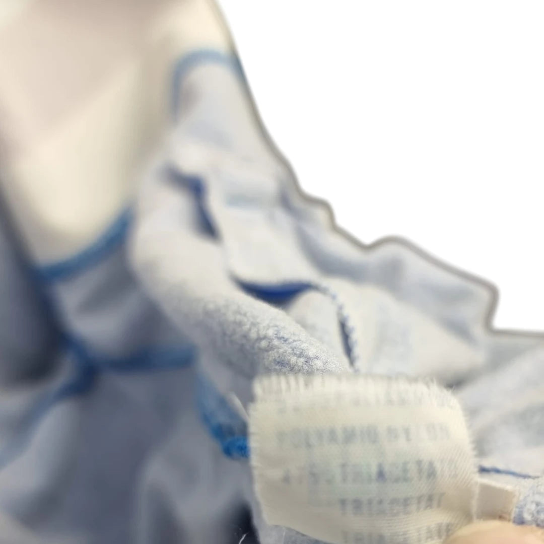 Dettaglio etichetta interna bianca sbiadita con indicazione dei materiali Polyamide Nylon e Triacetate.