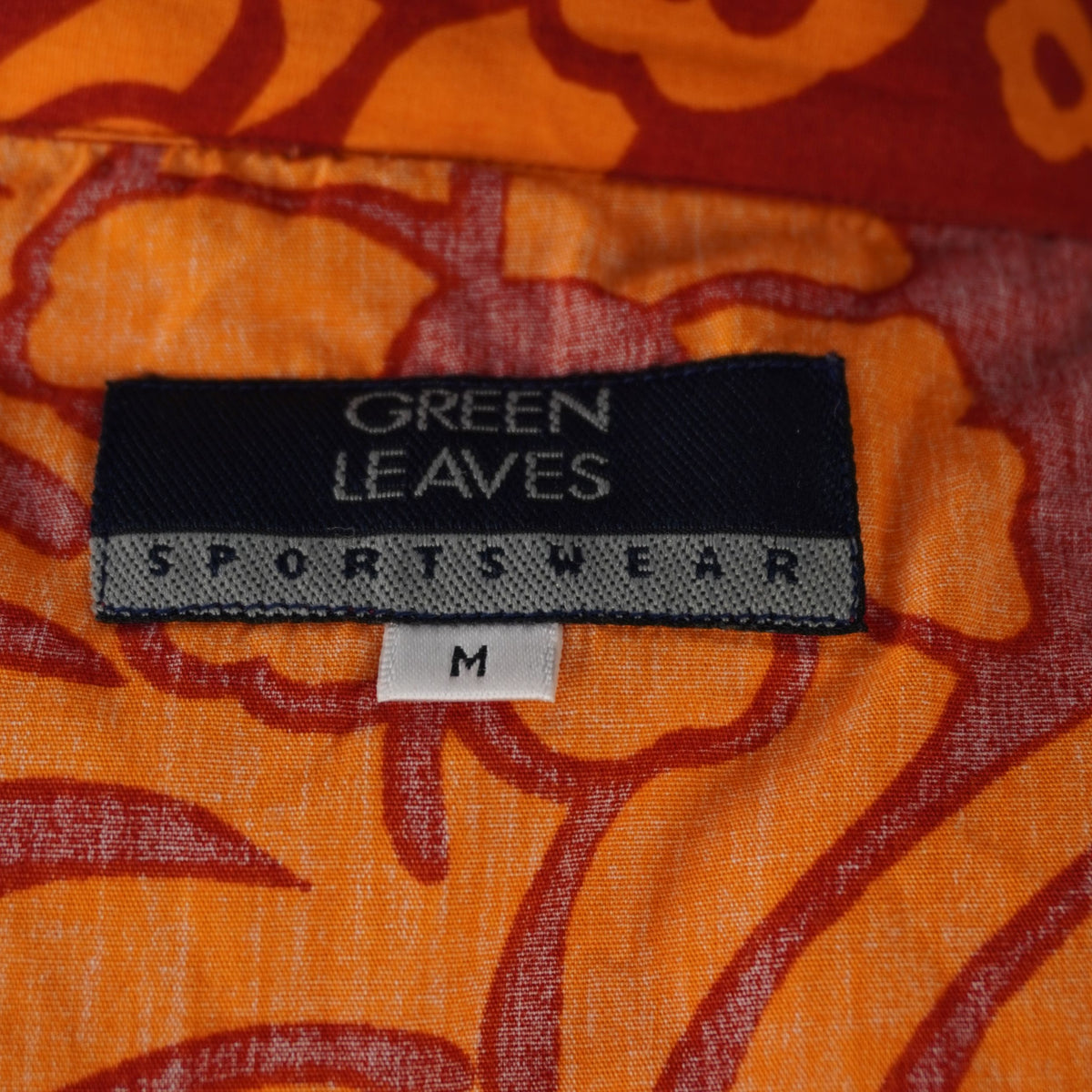 Camicia uomo arancione Green Leaves Sportswear con stampa floreale bianca, etichetta logo