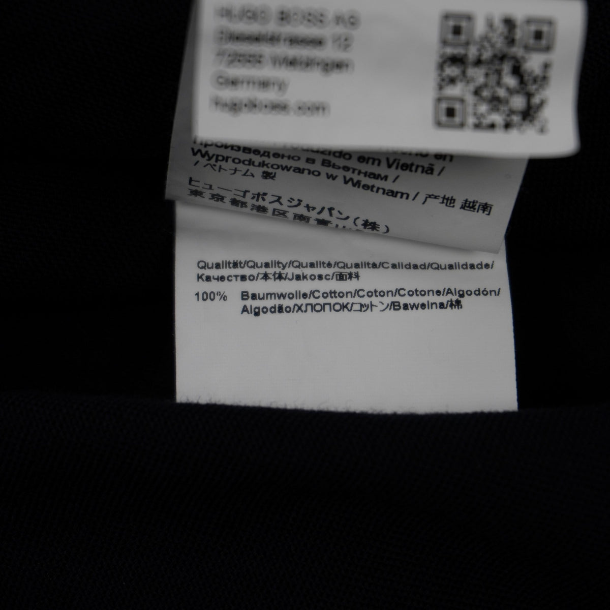 Etichetta bianca interna della camicia HUGO con i codici identificativi di produzione della linea.